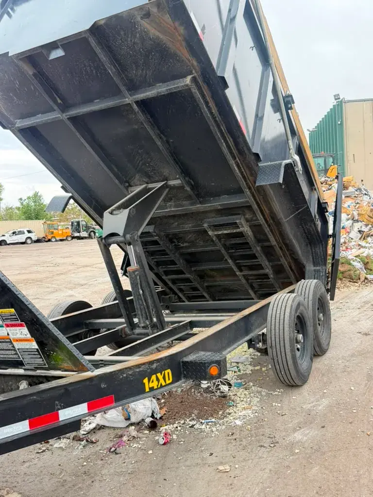 Dump trailer raised for debris disposal